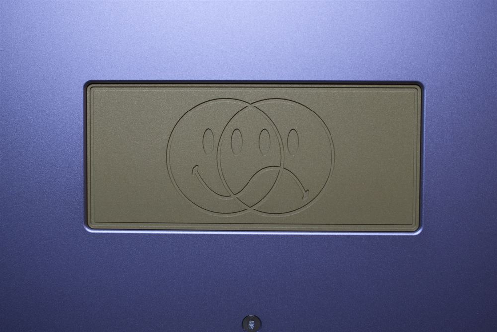 Extreme close-up of the brass weight with dual-face engraving
