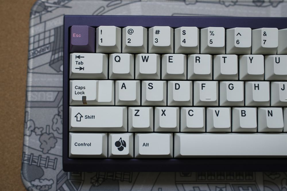 Angled close-up of the top-left corner with the Symbiote Esc accent