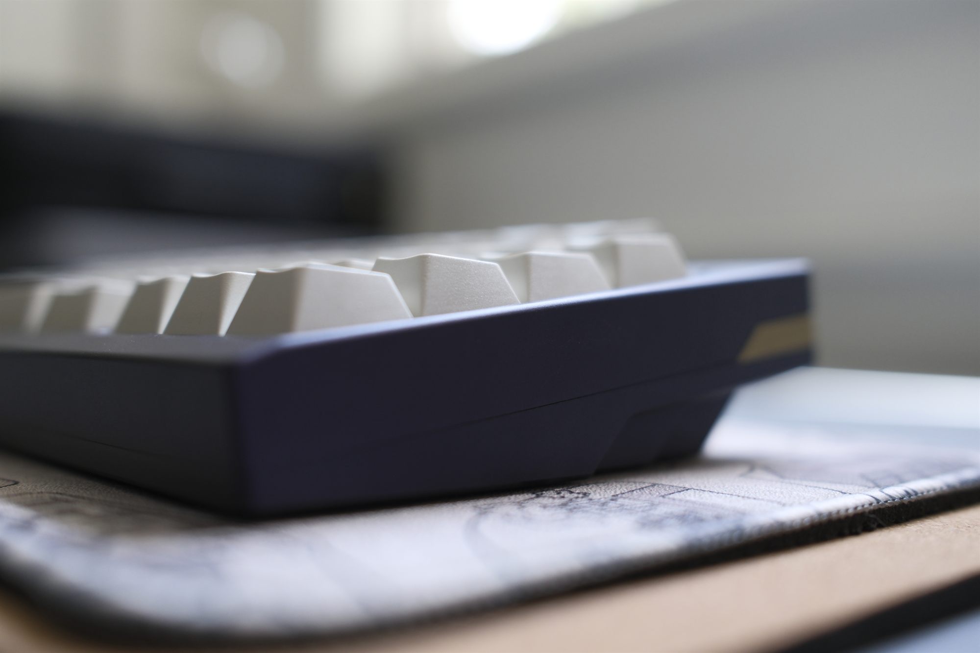 Drift Mechanics Forever 65, three-quarter side profile — purple anodized case with cream GMK Black Snail keycaps
