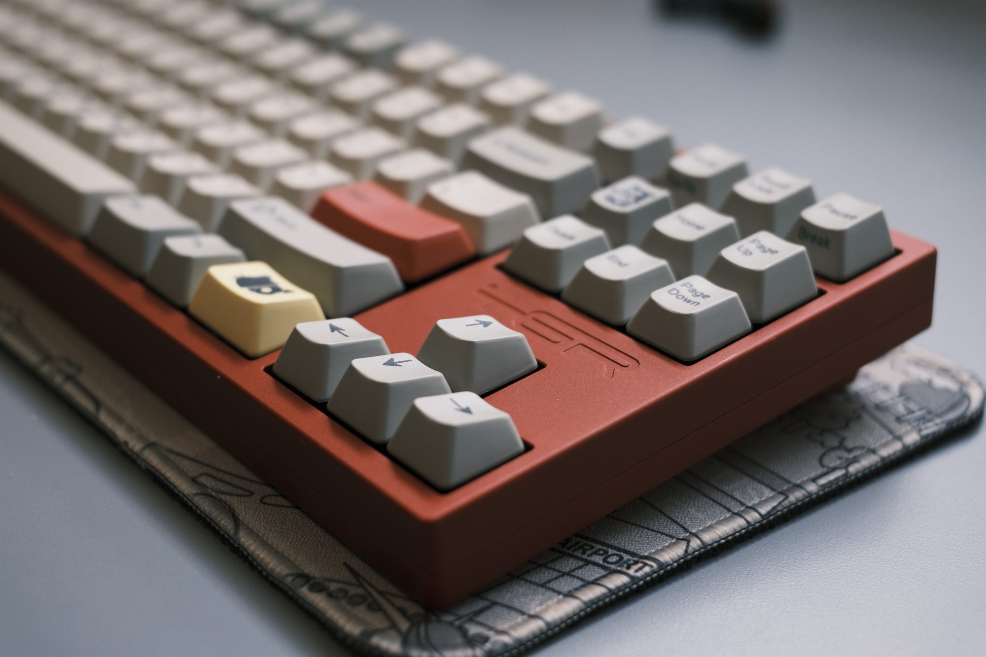 TGR Jane v2 CE, three-quarter profile — terracotta-red anodized case with DCS Deadbeats keycaps