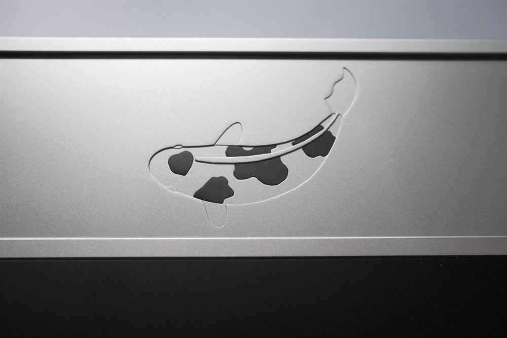 Macro of the koi-fish engraving on the stainless weight