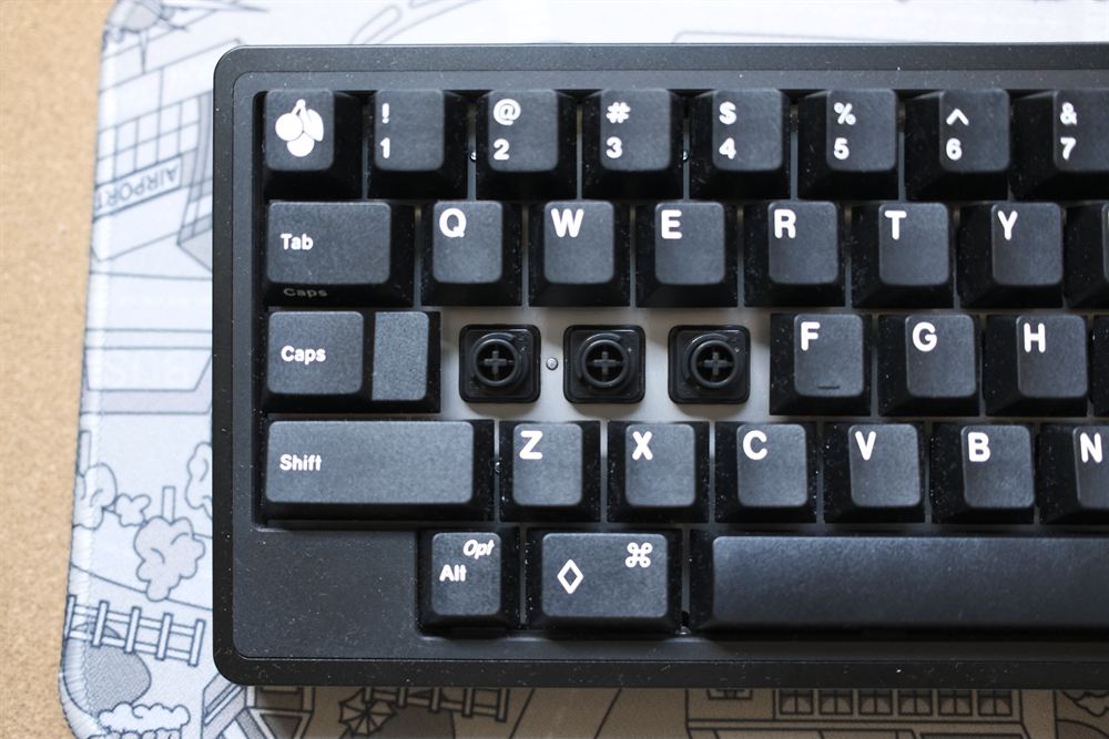 Three keycaps removed revealing the electrocapacitive Dynacap housings