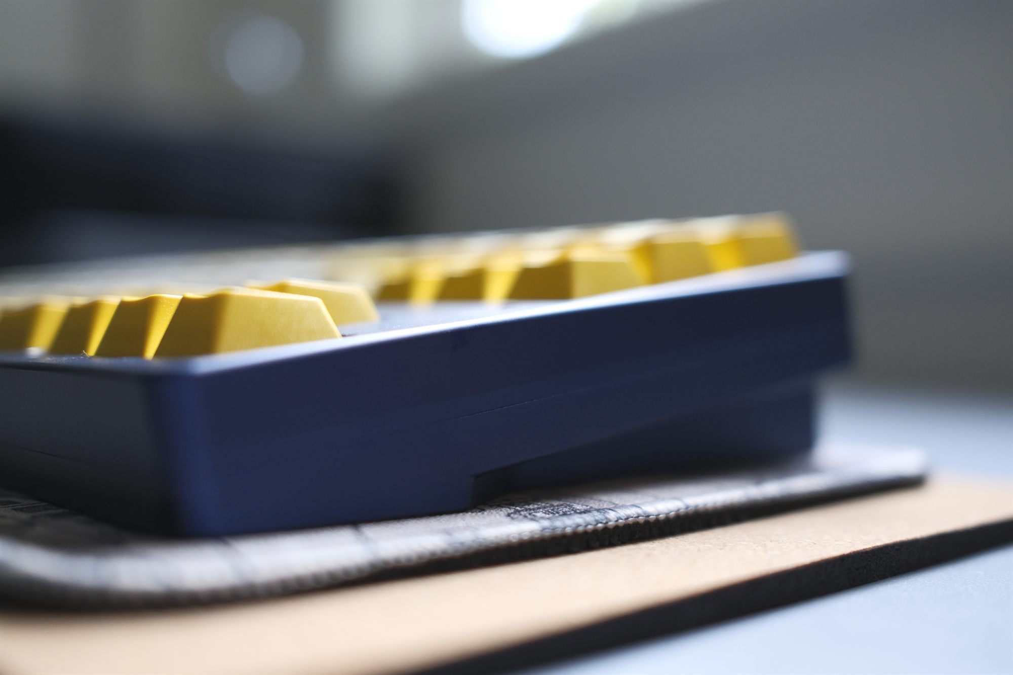 Spyder Gentian, side profile — gentian-blue anodized case with yellow and cream GMK Serika keycaps