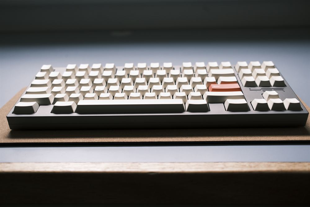 Front profile of the keyboard on a cork desk mat